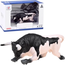 Animal figurine of black and white bull ready to charge