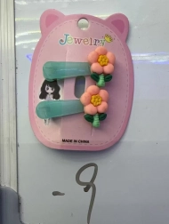 Ukopča za kosu s narančastim cvijetom