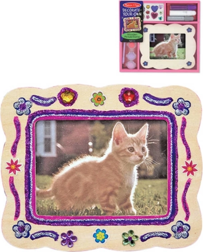 Creative kit for decorating a wooden picture frame with crayons and decorations