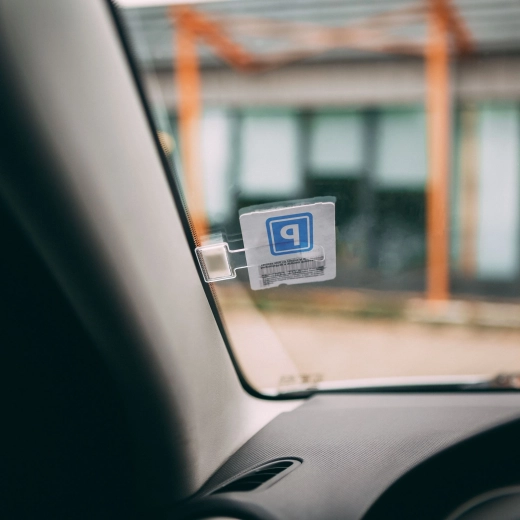 Self-adhesive parking ticket holder