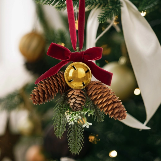 Christmas door decoration with a pine branch and golden bell