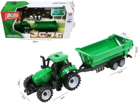 Zeleni traktor s prikolicom i priborom