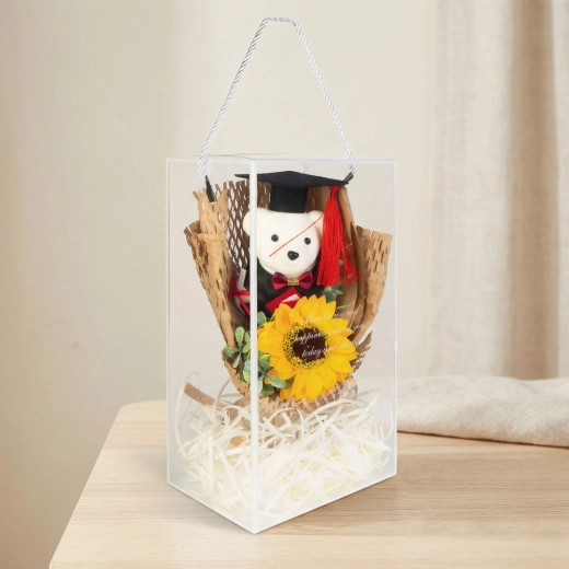 Artificial decoration with a sunflower and graduation teddy bear