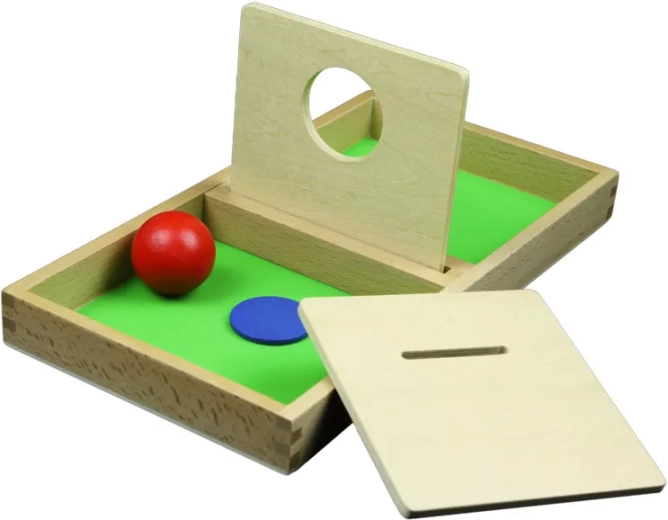 Wooden board with a hole for pushing a ball and a disc through
