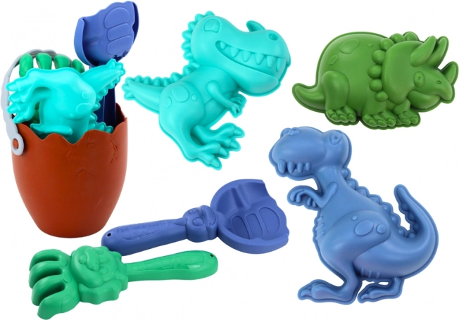 Pješčani set dinosauri s kantom u obliku jajeta, lopaticom, grabljicama i kalupima