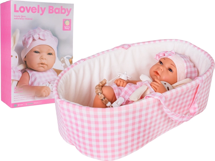 Baby doll in a pink carrier