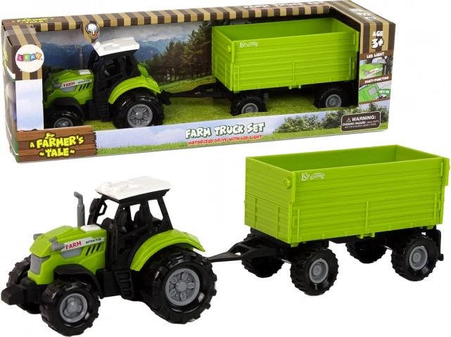 Zeleni poljoprivredni traktor s prikolicom
