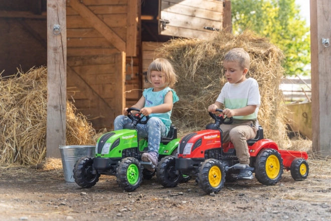 Pedalni traktor s prikolicom crveni