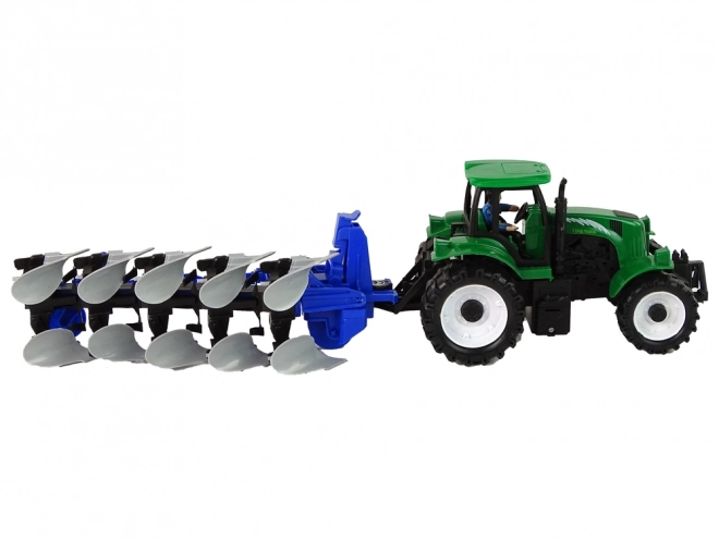 Zeleni poljoprivredni traktor s plugom