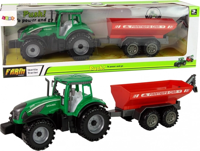 zeleni traktor s crvenom prikolicom s zamašnjakom
