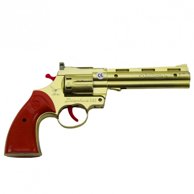 Zlatni revolver na kapisle s efektom zvuka pucnja